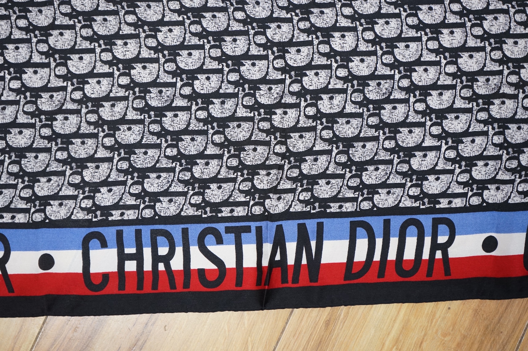Three silk scarves comprising a Burberry check example, Christian Dior monogrammed and a Vakko abstract patterned example